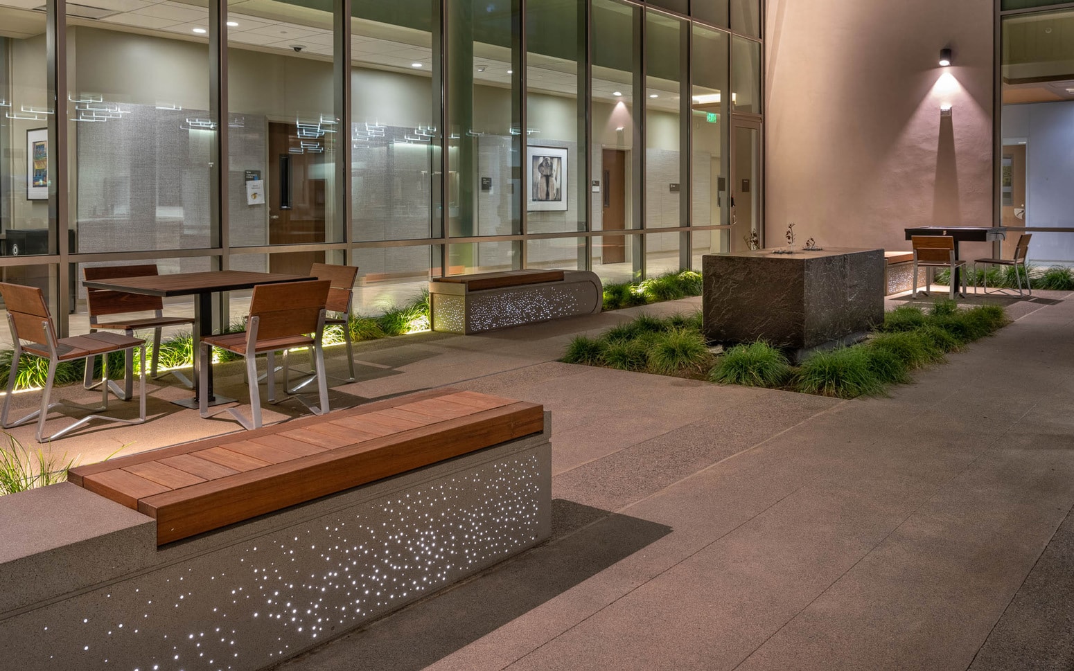 Pine lites lighting concrete benches at indoor patio