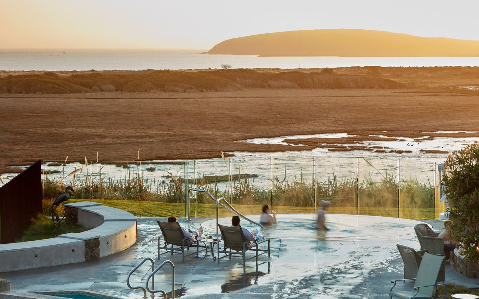 People enjoying the spa area with the view of the saltmarsh and ocean