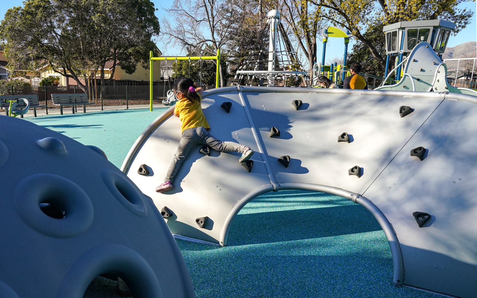 Child playing on play equipment