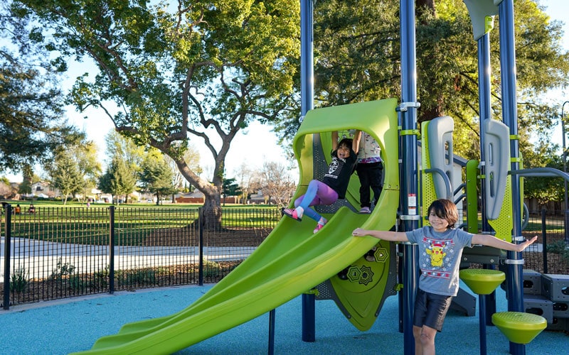 Two Girls Playing On The Slide