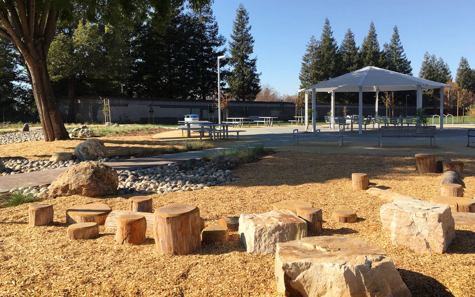 Picnic area with wood and rock stepping stones in mulched area