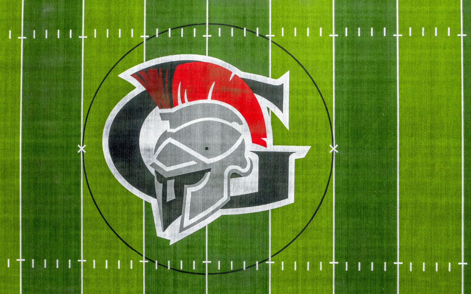 Gladstone logo on the synthetic field