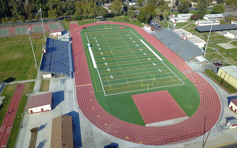 Drone Shot Of Football Field, Track And Bleachers