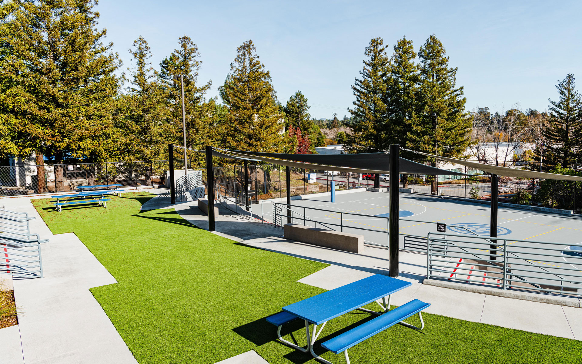 Basketball court, synthetic turf area, and picnic tables