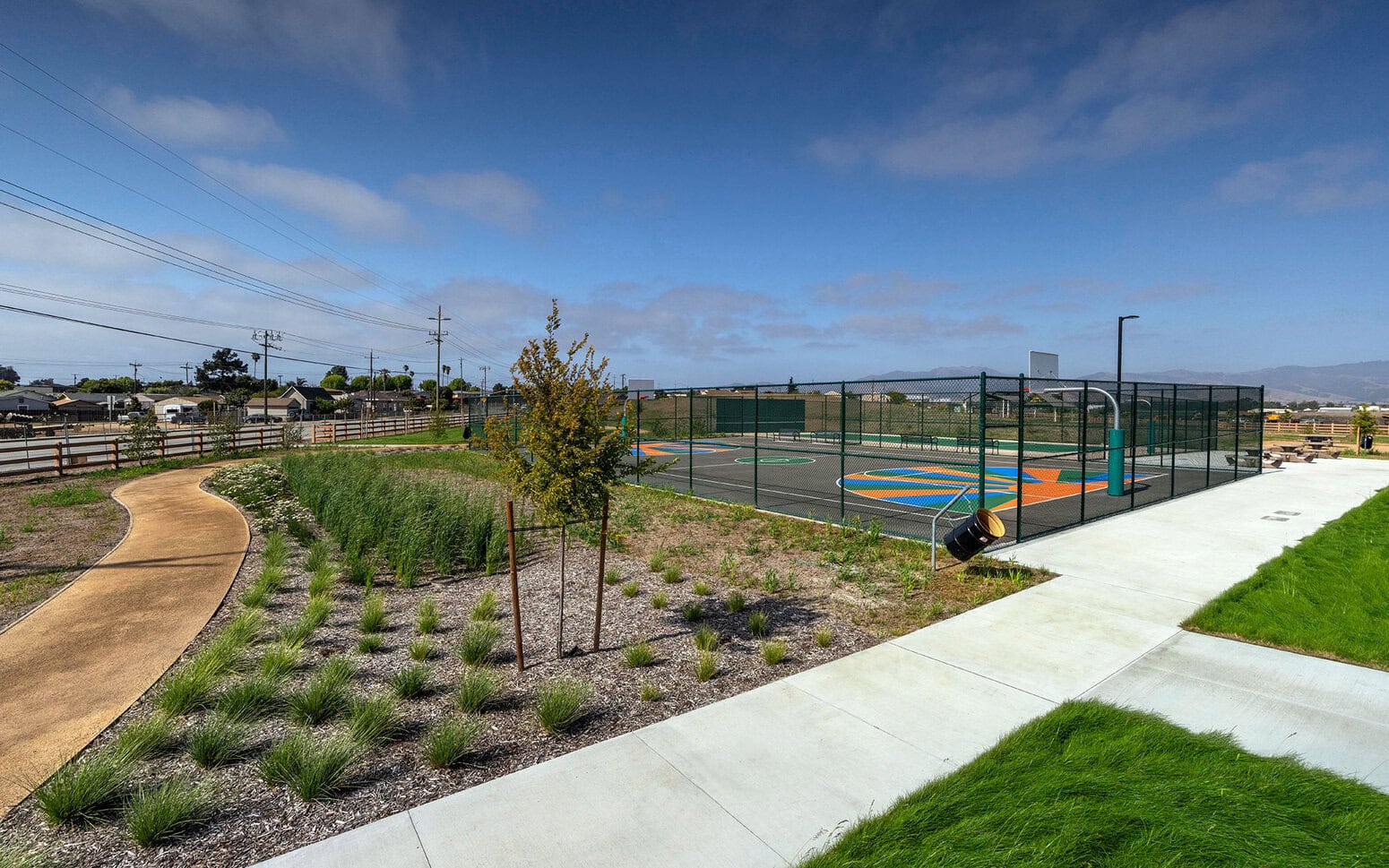 Path and fenced basketball court